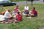 Friends picnicking on the lawn.