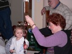 Terree shows her shiny new twirly wind chime to Samantha, who, like a little magpie, can't get enough.