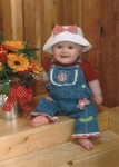 Samantha at six months with the flower arrangement that Mommy made.