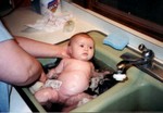 As per tradition, Samantha gets her bath in the cabin sink.