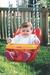 Samantha goes for a swing for the first time.  9 months.