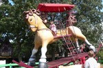 Samantha is riding Piccolo, the World's Largest Rocking Horse.