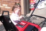 Sam helps Daddy get the snowblower put up for the summer.